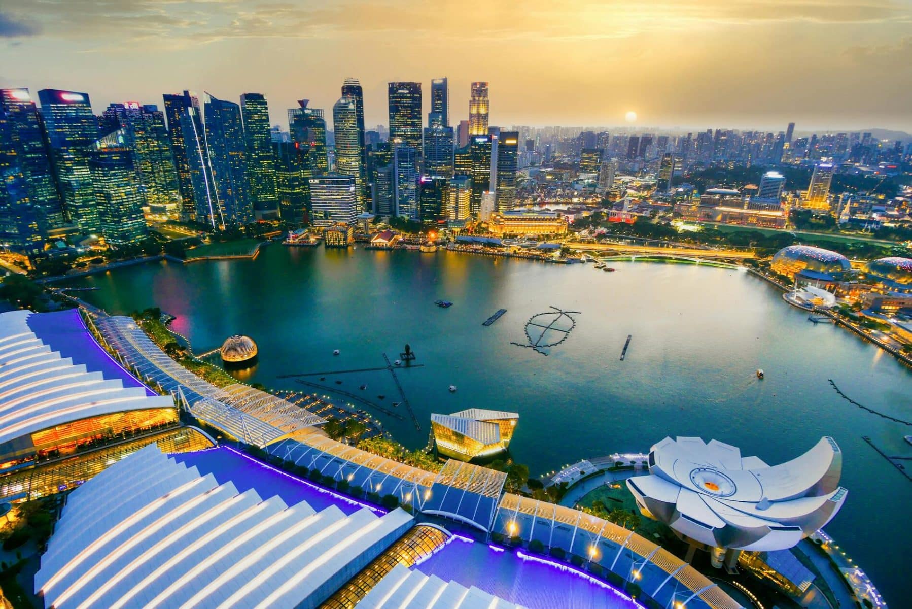 Singapore skyline at sunset over water
